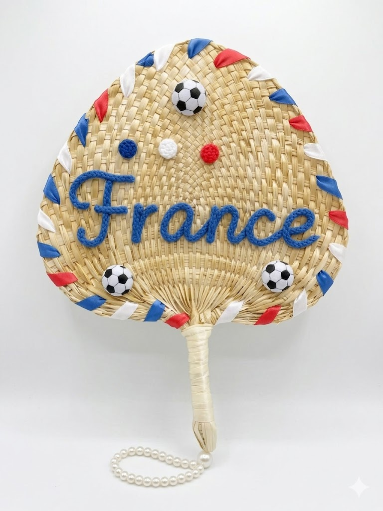 Woven hand fan with 'France' text and soccer ball designs on a white background